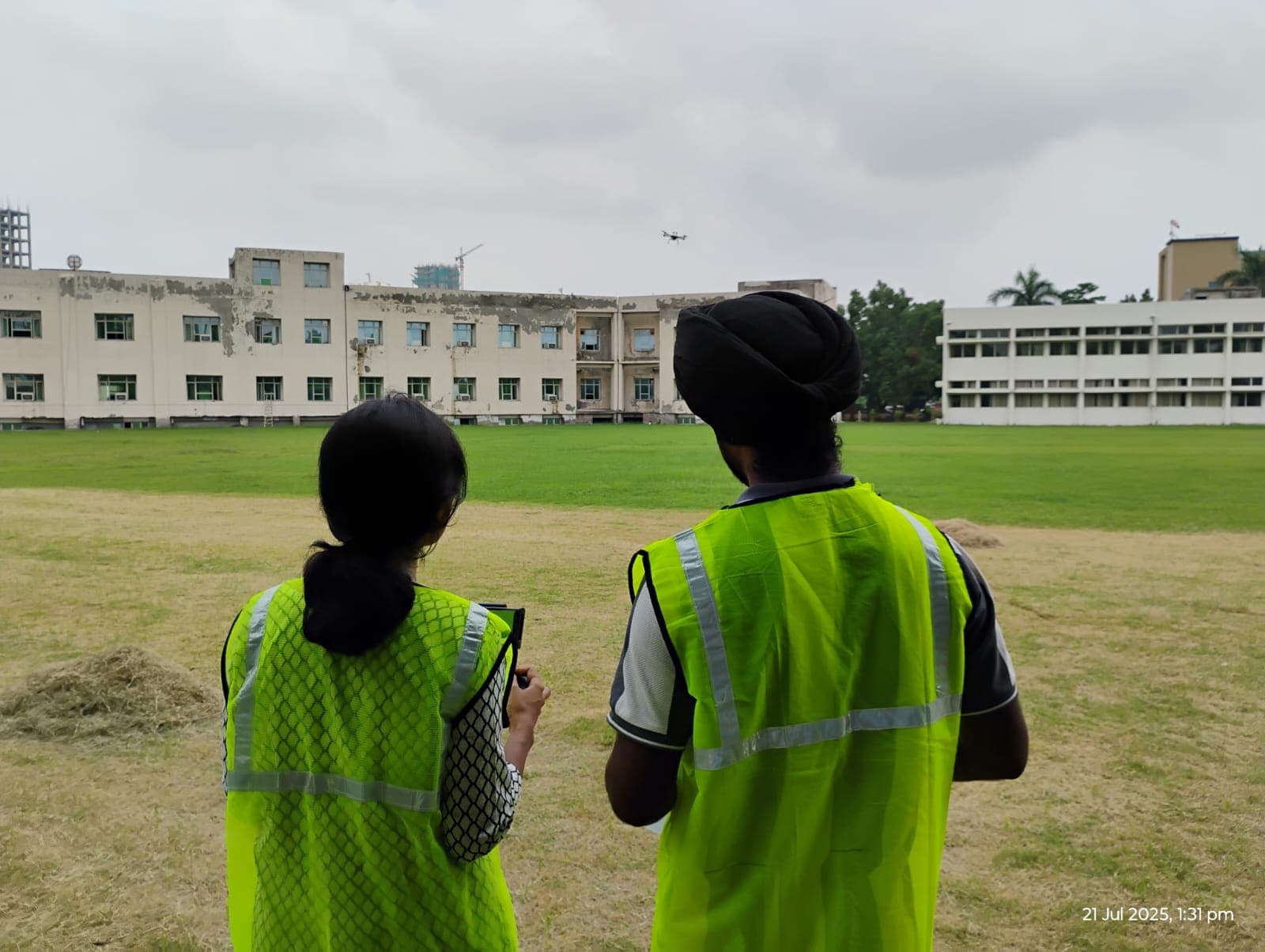 Drone trainees observing a live outdoor flight during practical training